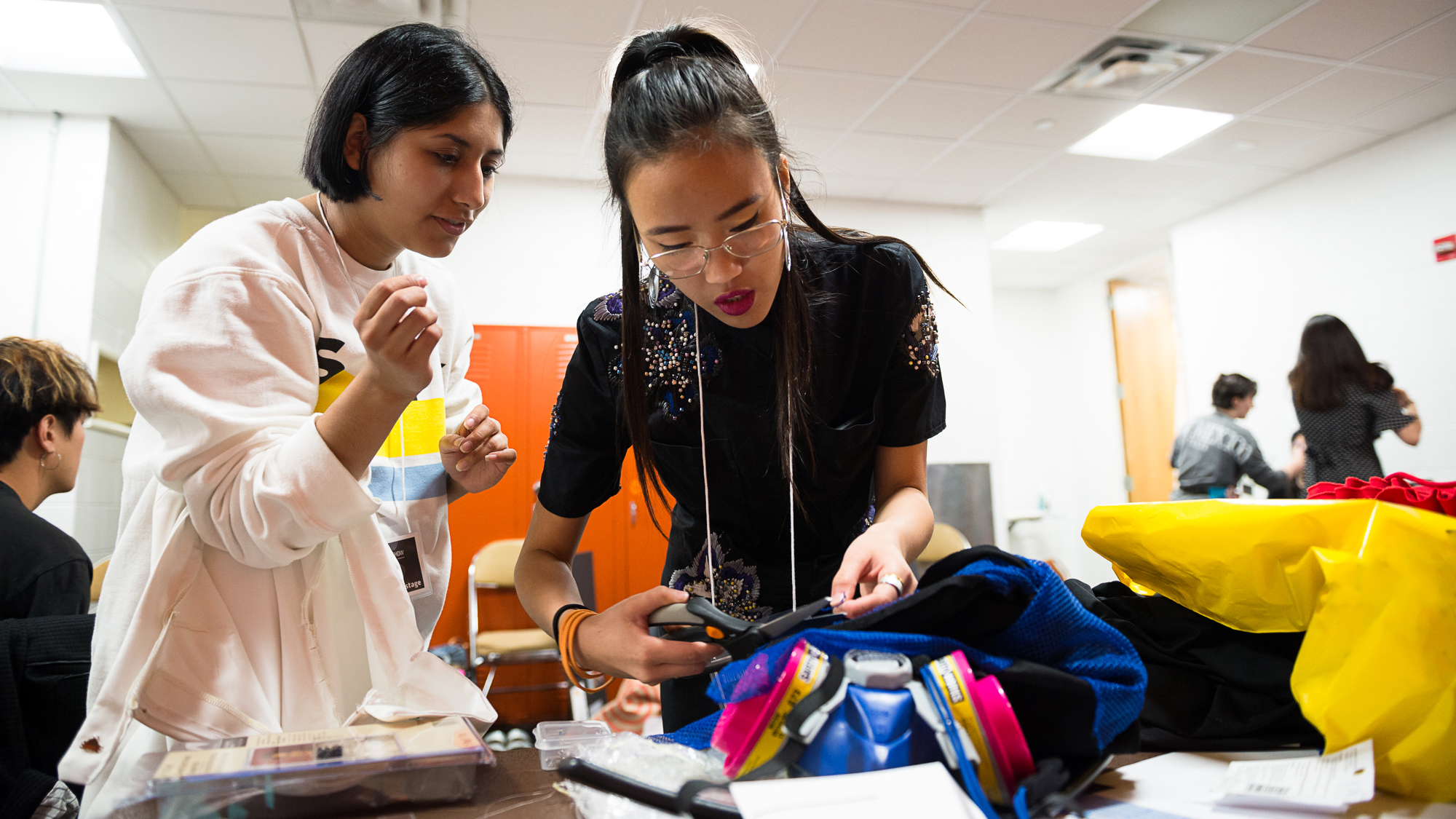 Two students prepare a garment for the Textiles and Apparel Fashion Show
