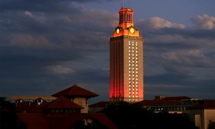 The UT Tower light up with orange lights at dusk
